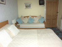 A view of Room 2 - kingsized bedroom with additional single bed