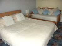 A view of Room 2 - kingsized bedroom with additional single bed