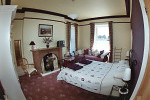 A view of Room 1 - kingsized bedroom with additional day bed