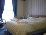 A view of Room 2 - kingsized bedroom with additional single bed