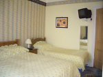A view of Room 2 - kingsized bedroom with additional single bed